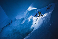 Daredevil snowboards in narrow ice cave