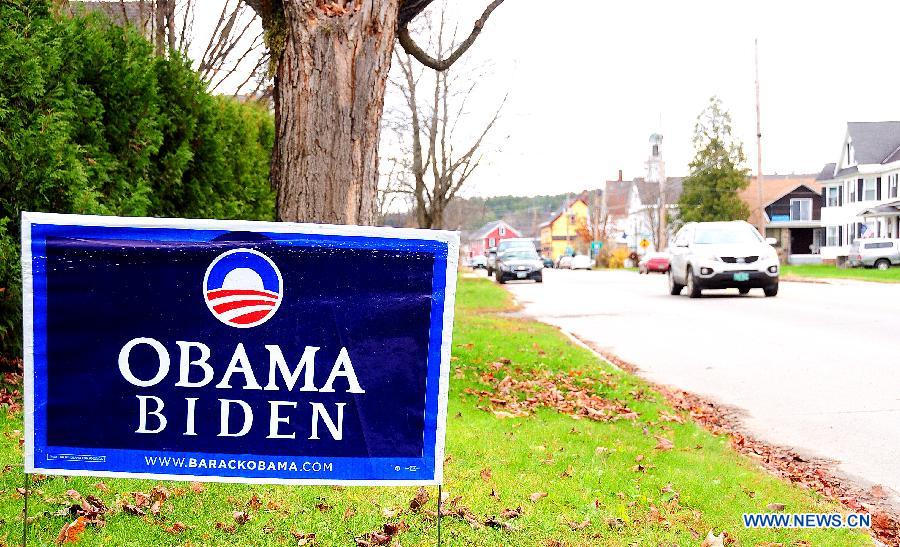 Cars run past a board showing support for U.S. President Barack Obama in Colebrook, New Hampshire, Nov. 5, 2012. The Americans will go to voting stations for the U.S. presidential election on Nov. 6, 2012. (Xinhua/Zhang Chuanshi) 