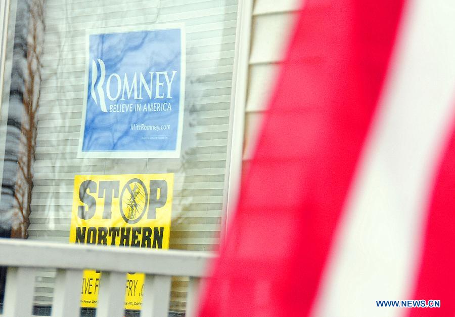 Pro-Romney poster and American national flag are seen at a local resident's house in Colebrook, New Hampshire, Nov. 5, 2012. The Americans will go to voting stations for the U.S. presidential election on Nov. 6, 2012. (Xinhua/Zhang Chuanshi) 