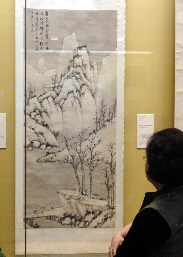 A visitor watches ancient Chinese calligraphy and painting works at Suzhou Museum in Suzhou of east China's Jiangsu Province, Nov. 6, 2012. (Xinhua/Chen Yu)