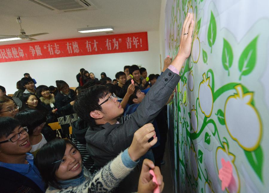 University students address their wishes to the 18th National Congress of the Communist Party of China (CPC) onto a wishing board in Hangzhou of east China's Zhejiang province, Nov. 8, 2012. The 18th CPC National Congress was opened in Beijing on Thursday. (Xinhua/Xu Yu) 