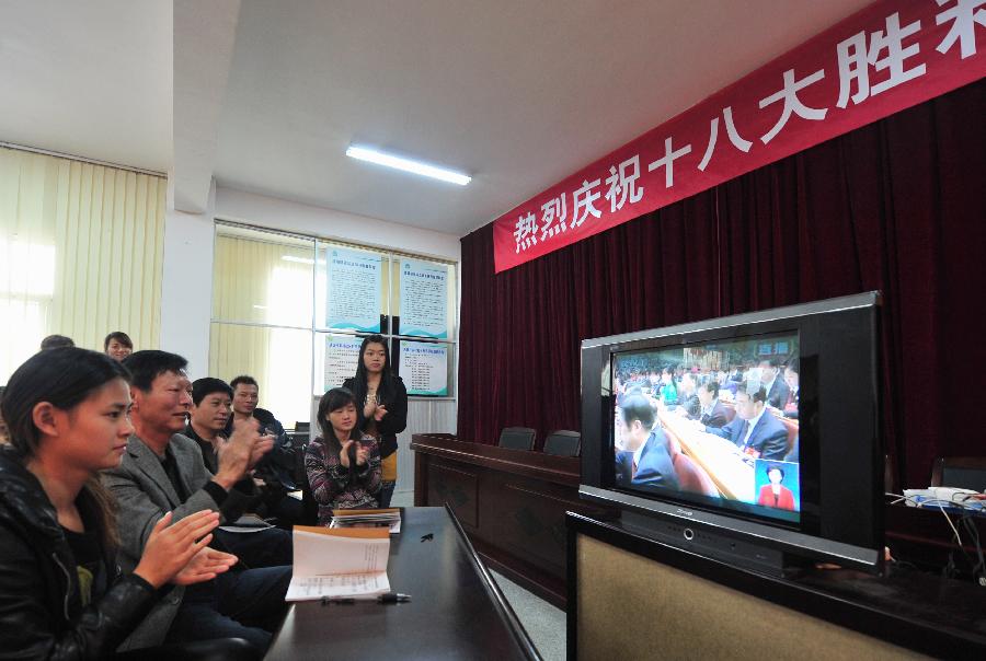 Local villagers watch TV reporting the opening ceremony of the 18th National Congress of the Communist Party of China (CPC) in Hongtian village of southeast China's Fujian province, Nov. 8, 2012. The 18th CPC National Congress was opened in Beijing on Thursday. (Xinhua/Wei Peiquan)