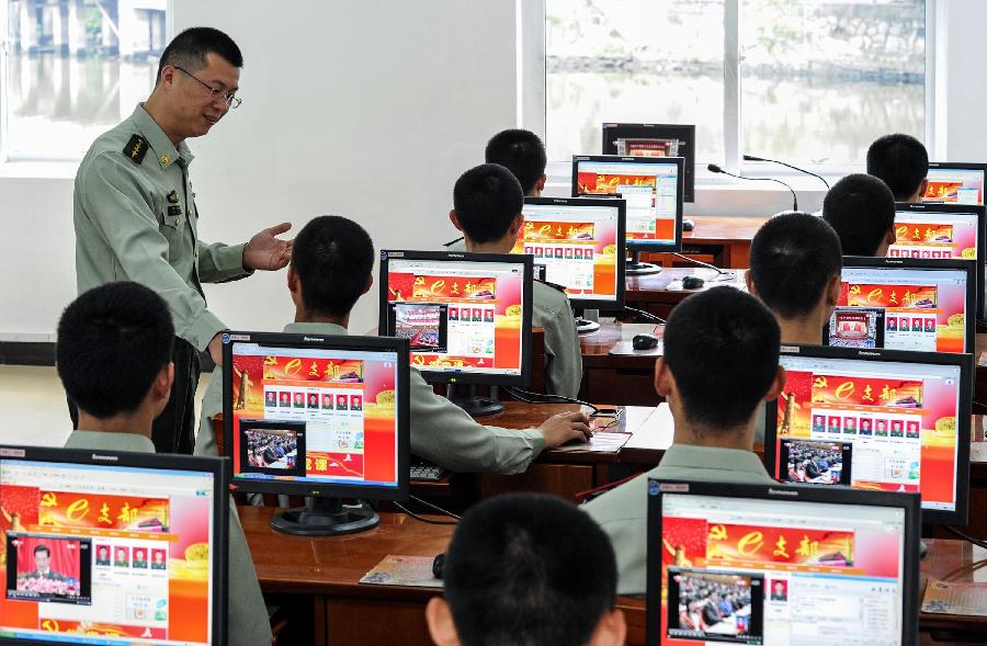 Soldiers read media reports on the opening ceremony of the 18th National Congress of the Communist Party of China (CPC) through the Local Area Network (LAN) in south China's Guangdong Province, Nov. 8, 2012. The 18th CPC National Congress was opened in Beijing on Thursday. (Xinhua/Liu Dawei)