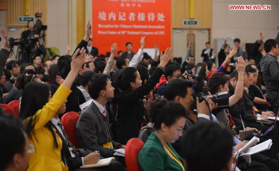 Journalists raise hands to ask questions during a group interview, with its theme "implement innovation strategies to accelerate transformation and development", which is held by the press center of the 18th National Congress of the Communist Party of China (CPC) in Beijing, capital of China, Nov. 10, 2012.(Xinhua/Li Xin)