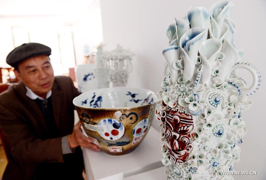 Ceramic artist Ren Ruihua works at his studio in Jingdezhen, east China's Jiangxi Province, Nov. 3, 2012. (Xinhua/Song Zhenping) 