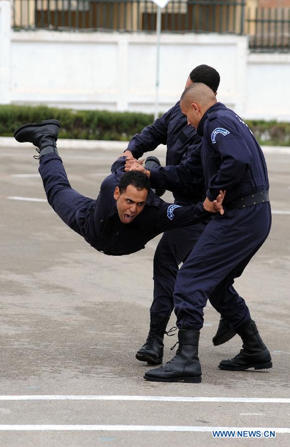 Algerian police students show their combat skills during the graduation ceremony, in Algiers, Algeria, on Nov. 12, 2012. A graduation ceremony was held Monday in the police academy in Ain Benian. (Xinhua/Mohamed Kadri)