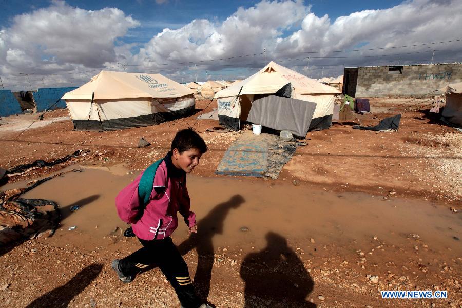 A Syrian refugee boy walks at Al Zaatri Syrian refugee camp in the Jordanian city of Mafraq, near the border with Syria, on Nov. 12, 2012. (Xinhua/Mohammad Abu Ghosh)