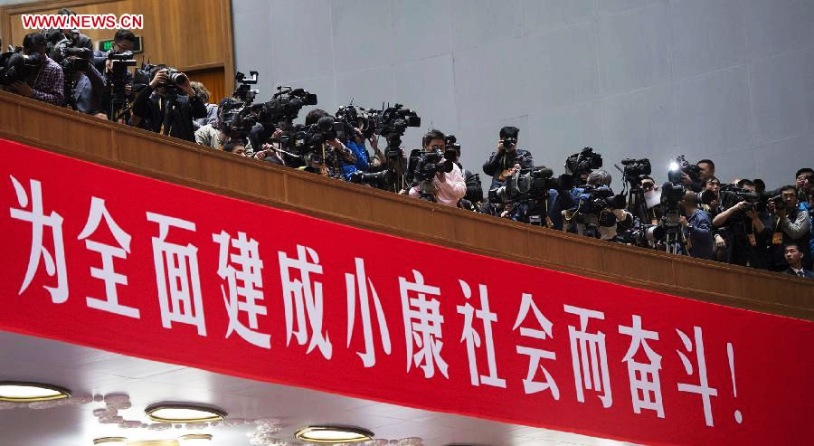 Journalists cover the closing session of the 18th National Congress of the Communist Party of China (CPC) at the Great Hall of the People in Beijing, capital of China, Nov. 14, 2012. (Xinhua/Huang Jingwen)