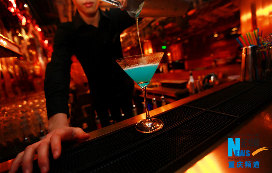 A bartender mixes drinks in World Shark Club in Chongqing on Oct. 31, 2012.