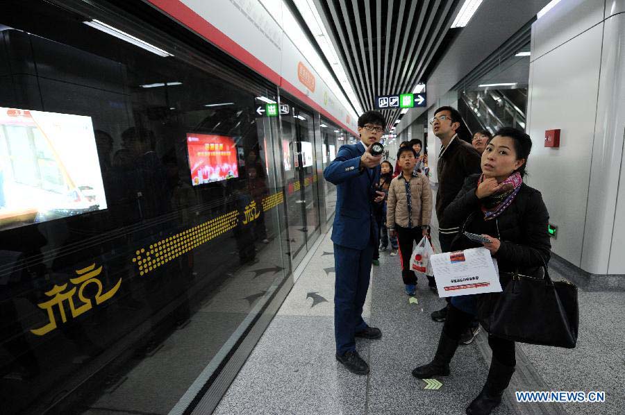 Passengers wait for a test ride on the soon-to-open Metro Line 1 in Hangzhou, capital of east China's Zhejiang Province, Nov. 18, 2012. 600,000 residents and journalists are invited for a test ride from Sunday to Wednesday on the newly built metro line. (Xinhua/Ju Huanzong) 