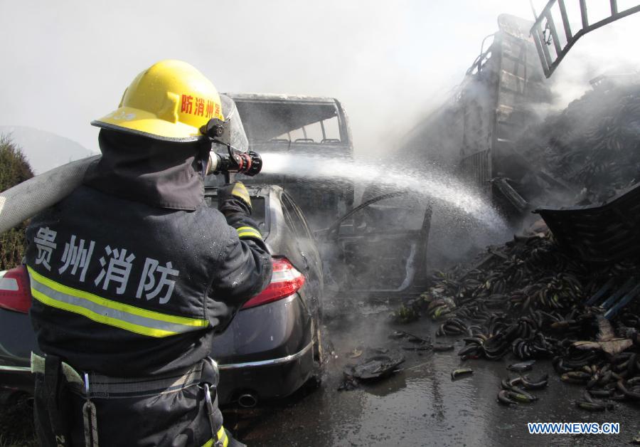 A fire fighter hoses down fire at a traffic accident site on the Shanghai-Kunming expressway in Anshun City, southwest China's Guizhou Province, Nov. 17, 2012. The pileup accident occurred at about 9 a.m. Saturday on the Hukun (Shanghai - Kunming) expressway in Anshun City, leaving nine people dead and 19 others injured. More than 25 vehicles involved in the accident, and seven of them burst into flames. (Xinhua/Tao Xuede)