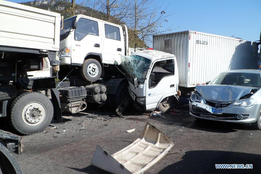 Photo taken on Nov. 17, 2012 shows a traffic accident site on the Shanghai-Kunming expressway in Anshun City, southwest China's Guizhou Province. The pileup accident occurred at about 9 a.m. Saturday on the Hukun (Shanghai - Kunming) expressway in Anshun City, leaving nine people dead and 19 others injured. More than 25 vehicles involved in the accident, and seven of them burst into flames. (Xinhua)