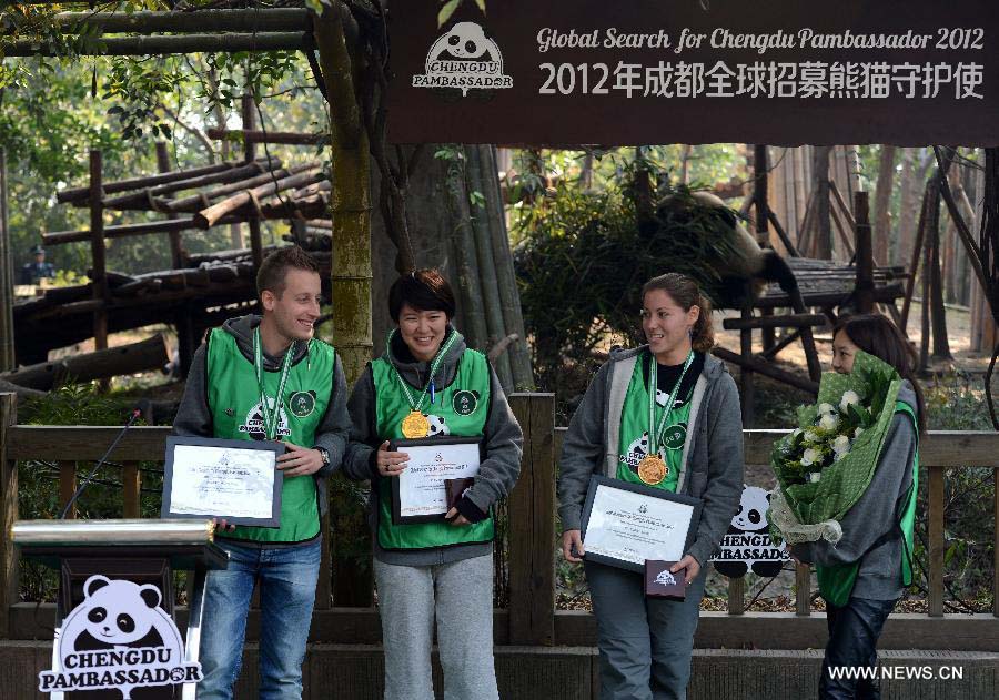 French contestant Jerome Serge Pouille (1st L), Chinese contestant Chen Yinrong (2nd L) and American contestant Melissa Rose Katz (2nd R) pose for a group photo during the final of "global search for Chengdu Pambassador 2012" at the Research Base for Giant Panda Breeding in Chengdu, capital of southwest China's Sichuan Province, Nov. 17, 2012. Jerome Serge Pouille, Chen Yinrong and Melissa Rose Katz, the top three winners from the final, will serve as the Chengdu Pambassador for a year. They will train at the Chengdu Research Base of Giant Panda Breeding before travelling around the world to all the countries and regions that have giant pandas. The global initiative is aimed to raise the awareness about the protection of the giant panda, a high endangered species, and their habitats. (Xinhua/Jiang Hongjing)