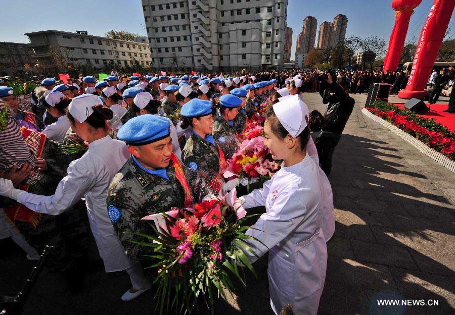 Members of the medical team of the 14th batch of Chinese peacekeeping force for Liberia receive flowers during a departure ceremony in Tianjin, north China, Nov. 13, 2012. The first batch of a 43-member Chinese medical personnel group left for Liberia on a eight-month UN peacekeeping mission here on Tuesday. (Xinhua/Zhang Chaoqun)
