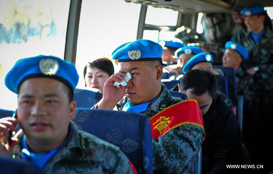 A member of the medical team of the 14th batch of Chinese peacekeeping force for Liberia sheds tears after he bids farewell to colleagues in Tianjin, north China, Nov. 13, 2012. The first batch of a 43-member Chinese medical personnel group left for Liberia on a eight-month UN peacekeeping mission here on Tuesday. (Xinhua/Zhang Chaoqun)