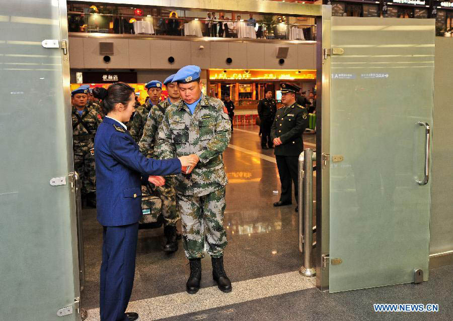 Members of the medical team of the 14th batch of Chinese peacekeeping force for Liberia check in at the Capital International Airport in Beijing, capital of China, Nov. 13, 2012. The first batch of a 43-member Chinese medical personnel group left for Liberia on a eight-month UN peacekeeping mission on Tuesday. (Xinhua/Zhang Chaoqun)