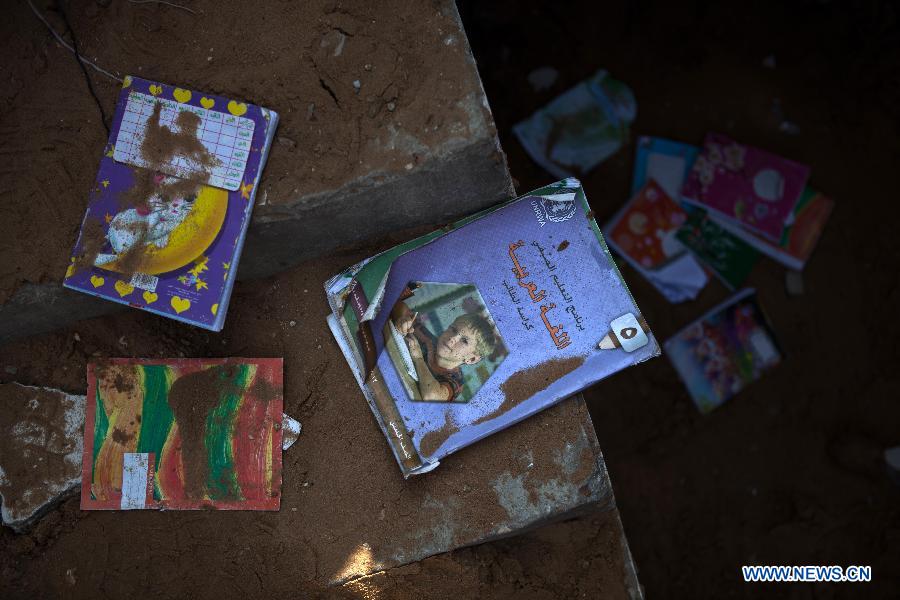 Books of UN Relief and Works Agency for Palestine Refugees in the Near East (UNRWA) are seen in a Palestinian house destroyed during an Israeli air strike in Gaza City, Nov. 20, 2012. Hamas-run Ministry of Health said the death toll since Wednesday in the Gaza Strip has climbed to 130 and more than 1,000 people were wounded in the ongoing Israeli aerial operation on the coastal enclave. (Xinhua/Chen Xu) 
