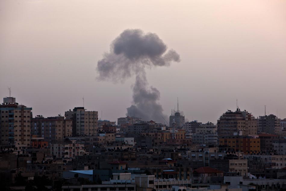 Flames and smoke rise from Gaza City after Israeli air strikes on Nov. 17, 2012. (Xinhua/Chen Xu)