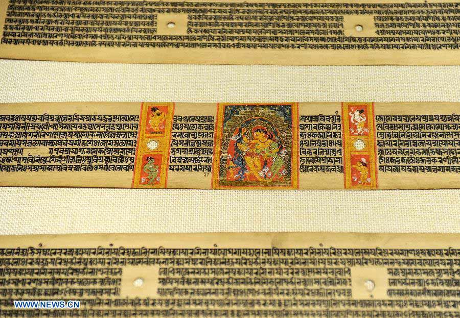 Photo taken on Nov. 21, 2012 shows the Palm-Leaf Manuscripts of Buddhist Sutras in Lhasa, capital of southwest China's Tibet Autonomous Region. The palm-leaf manuscripts of Buddhist sutras have been well preserved in China. Palm-Leaf sutras refer to the Buddhist classics inscribed on the leaves of palm trees. The practice originated in India and was introduced into China more than 1,000 years ago during the Tang Dynasty (618-907).(Xinhua/Chogo)