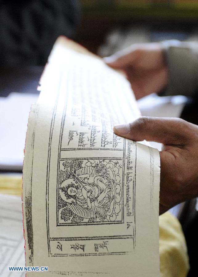 Photo taken on Nov. 21, 2012 shows the photocopy of Palm-Leaf Manuscripts of Buddhist Sutras in Lhasa, capital of southwest China's Tibet Autonomous Region. The palm-leaf manuscripts of Buddhist sutras have been well preserved in China. Palm-Leaf sutras refer to the Buddhist classics inscribed on the leaves of palm trees. The practice originated in India and was introduced into China more than 1,000 years ago during the Tang Dynasty (618-907).(Xinhua/Chogo)