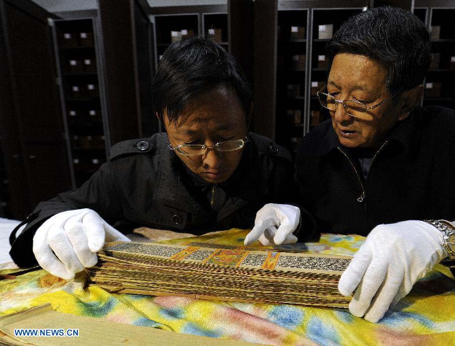 Scholars study Palm-Leaf Manuscripts of Buddhist Sutras in Lhasa, capital of southwest China's Tibet Autonomous Region, Nov. 21, 2012. The palm-leaf manuscripts of Buddhist sutras have been well preserved in China. Palm-Leaf sutras refer to the Buddhist classics inscribed on the leaves of palm trees. The practice originated in India and was introduced into China more than 1,000 years ago during the Tang Dynasty (618-907).(Xinhua/Chogo)