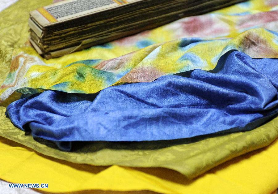 Photo taken on Nov. 21, 2012 shows the cloth used to perserve Palm-Leaf Manuscripts of Buddhist Sutras in Lhasa, capital of southwest China's Tibet Autonomous Region. The palm-leaf manuscripts of Buddhist sutras have been well preserved in China. Palm-Leaf sutras refer to the Buddhist classics inscribed on the leaves of palm trees. The practice originated in India and was introduced into China more than 1,000 years ago during the Tang Dynasty (618-907).(Xinhua/Chogo)