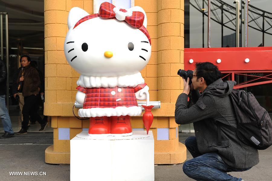 A man takes pictures of a Hello Kitty at the Joy City in east China's Shanghai Municipality, Nov. 26, 2012. A big Hello Kitty exhibition themed on Hello Kitty's exploration in the polar regions would last from Nov. 24, 2012 to Feb. 24, 2013 in Shanghai. (Xinhua/Lai Xinlin) 