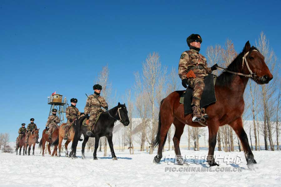 The officers and men of a frontier defense company under the Ili Military Sub-Command of the Xinjiang Military Area Command (MAC) of the Chinese People's Liberation Army (PLA) are patrolling on horseback on November 23, 2012. (chinamil.com.cn/Zhu Dehua)