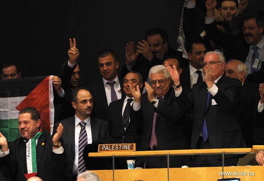 Palestinian President Mahmoud Abbas (C) and the delegation celebrate at the UN General Assembly (UNGA) meeting at the UN headquarters in New York, the United States, on Nov. 29, 2012. The UNGA on Thursday voted overwhelmingly to grant an upgrade of the Palestinians status at the United Nations from "entity" to "non-member state". (Xinhua/Shen Hong)