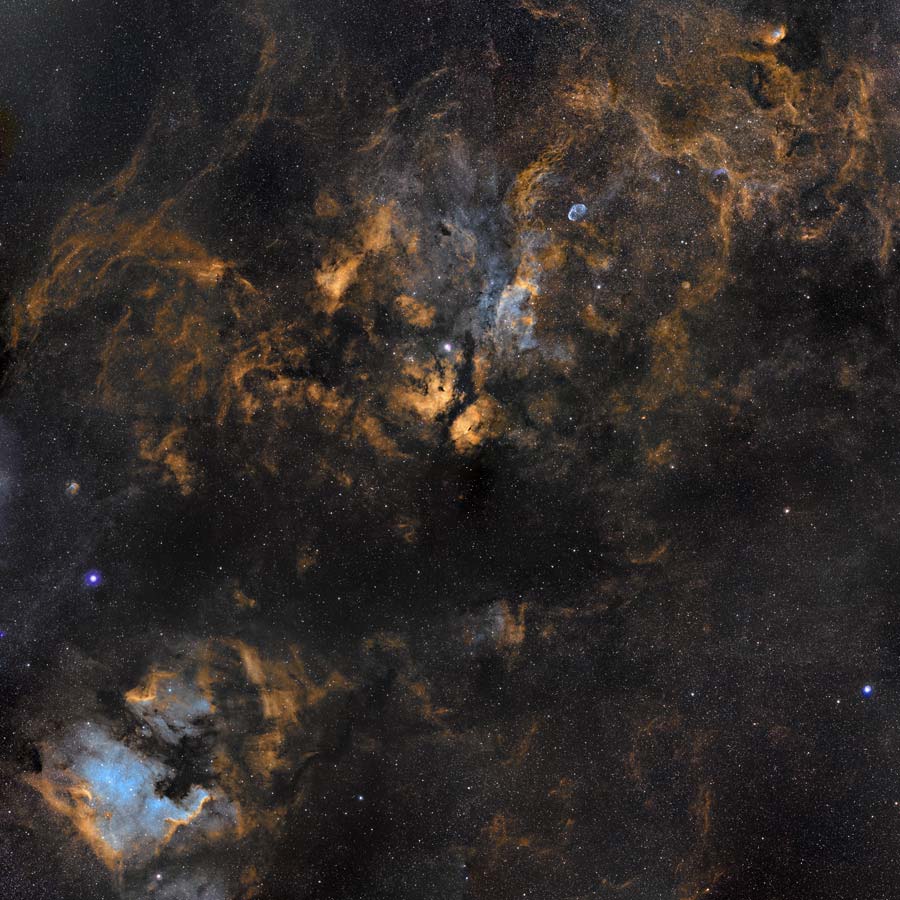Clouds in Cygnus. Cosmic clouds of gas and dust drift across this magnificent mosaic covering a 12x12 degree field within the high flying constellation Cygnus. The collaborative skyscape, a combination of broad and narrow band image data presented in the Hubble palette, is anchored by bright, hot, supergiant star Deneb, below center near the left edge. (Photo/ NASA)