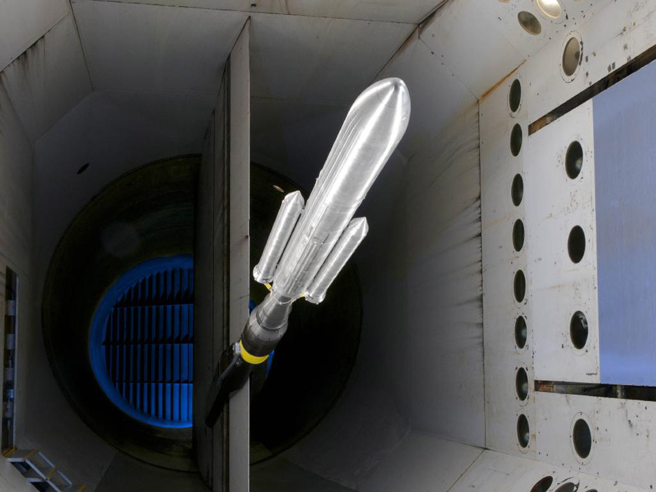 SLS Model 'Flies' Through Langley Wind Tunnel Testing. NASA's Space Launch System buffet model in NASA's Langley Researcher Center's Transonic Dynamics Tunnel. The SLS is America's next heavy-lift launch vehicle that will provide an entirely new capability for science and human exploration beyond Earth's orbit. (Photo/ NASA)