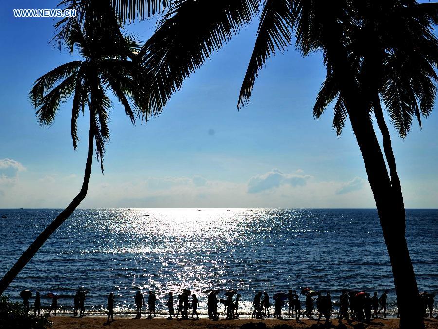 Tourists visit the Tianya Haijiao ("Edges of the heaven, corners of the sea") resort in Sanya, south China's Hainan Province, Dec. 1, 2012. Sanya has always been a winter tourism preference thanks to its tropical climate. (Xinhua/Hou Jiansen)