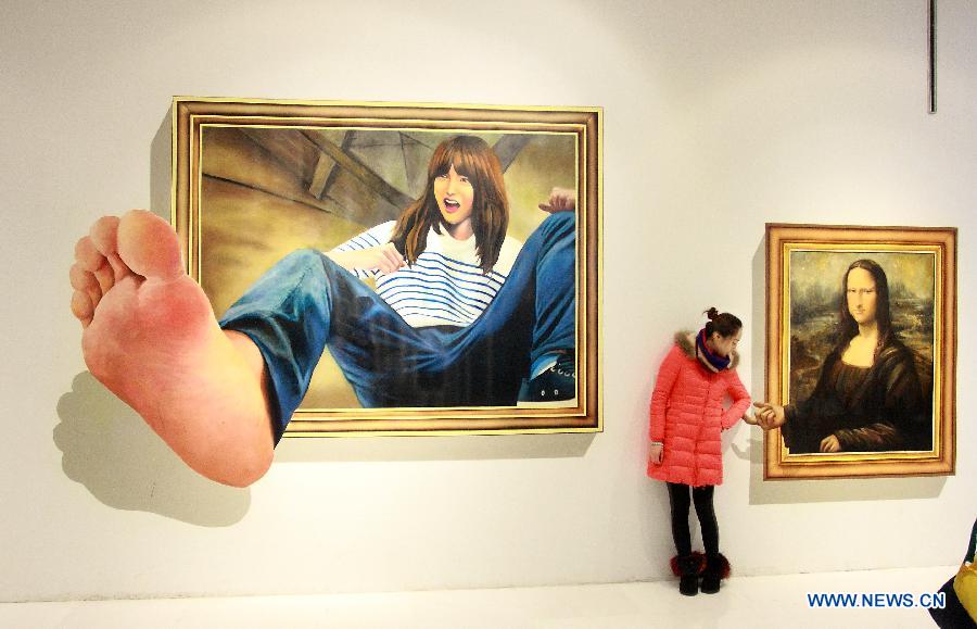 A visitor poses with a three dimensional painting during an exhibition in Tianjin, north China, Dec. 1, 2012. (Xinhua/Wang Qingyan)