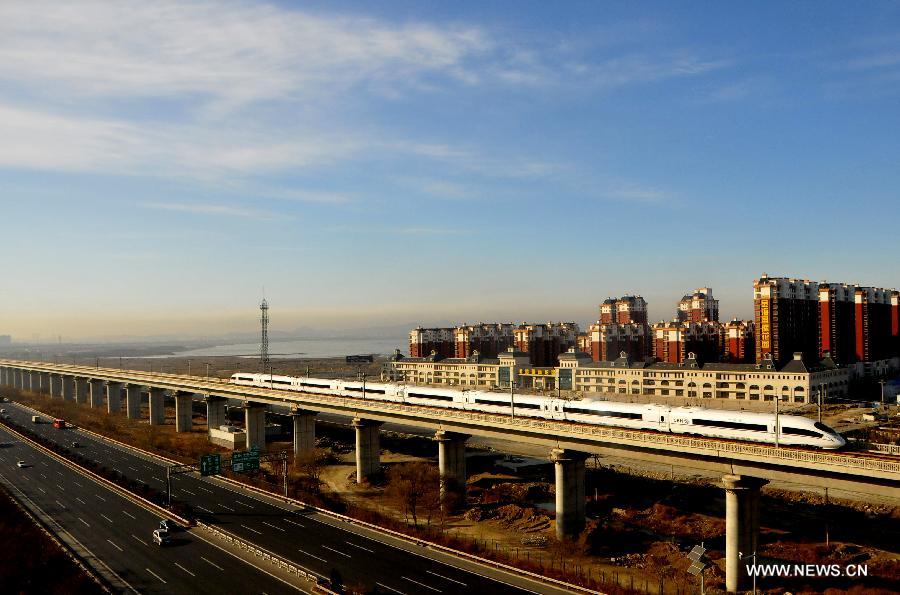 A high-speed train from Dalian North Railway Station to Harbin West Railway Station runs at the Jinzhou New District section in Dalian, northeast China's Liaoning Province, Dec. 1, 2012.  (Xinhua/Lv Wenzheng)