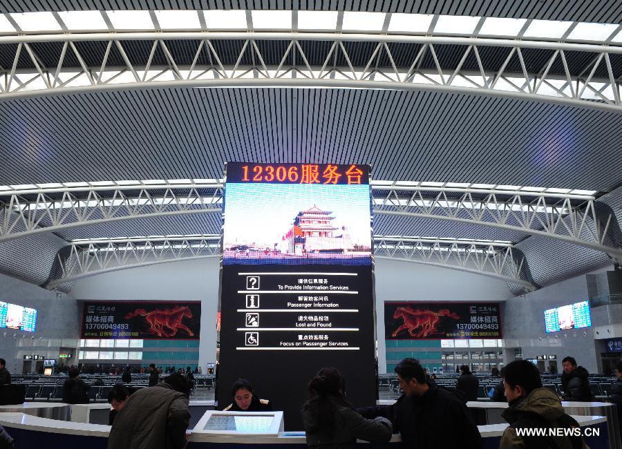 Passengers seek for information at the waiting area for high-speed trains at the Shenyang North Railway Station in Shenyang, capital of northeast China's Liaoning Province, Dec. 1, 2012.  (Xinhua/Pan Yulong)