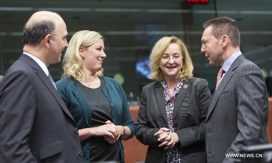 French Economy and Finance Minister Pierre Moscovici, Finnish Finance Minister Jutta Urpilainen, Austrian Finance Minister Maria Fekter and Greek Finance Minister Yannis Stournaras (L to R) talk during a Eurogroup finance ministers meeting at EU's headquarters on December 3, 2012, in Brussels, capital of Belgium.(Xinhua/Thierry Monasse)
