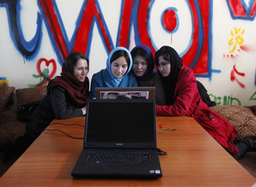 Afghan girls work in the first feminine Internet café on March 8, 2012. (Reuters/Mohammad Ismail)