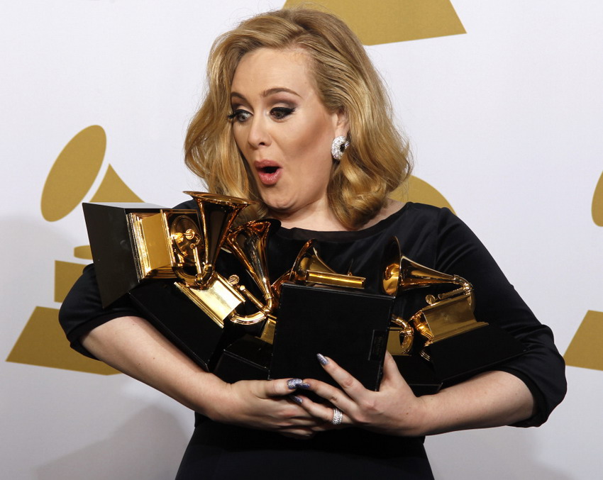 Signer Adele holds her six Grammy Awards trophies at the 54th Grammy Awards Ceremony in Los Angeles on Feb 12, 2012. (Reuters/Lucy Nicholson)