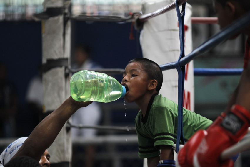 An eight-year-old boy Ulises drinks water during a training session in a low-income community gym center, in Panama City on May 3, 2012. (Reuters/Carlos Jasso)