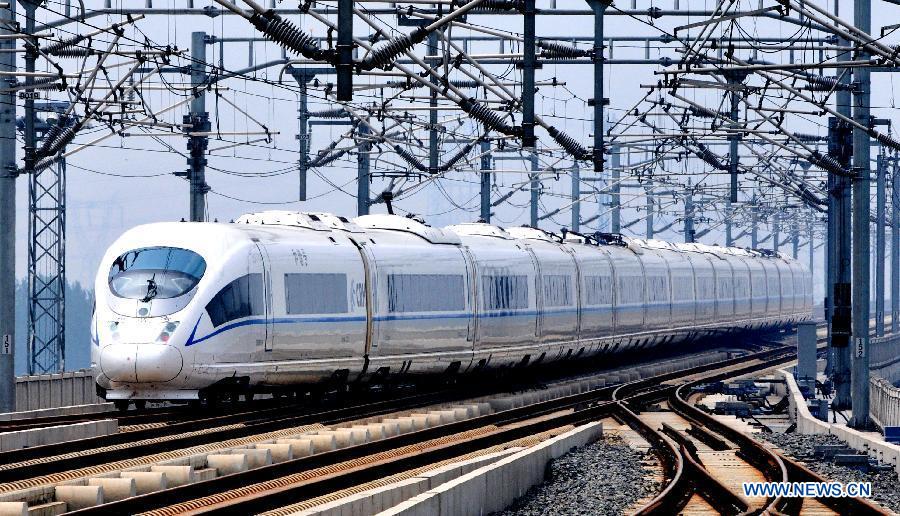 Photo taken on June 30, 2012 shows a high-speed train leaving Tianjin South Railway Station in Tianjin, north China. China's electric railway mileage has surpassed 48,000 kilometers, ranking first in the world, the China Railway Engineering Corporation Railway Electrification Bureau Group Co., Ltd. (EEB) said on Dec. 4, 2012. Wang Zuoxiang, head of the EEB technology department, said the country started to build electric railways in 1958, and in just over half a century, the mileage has exceeded that of Russia, the former country with the most electric railway mileage. (Xinhua/Yang Baosen)