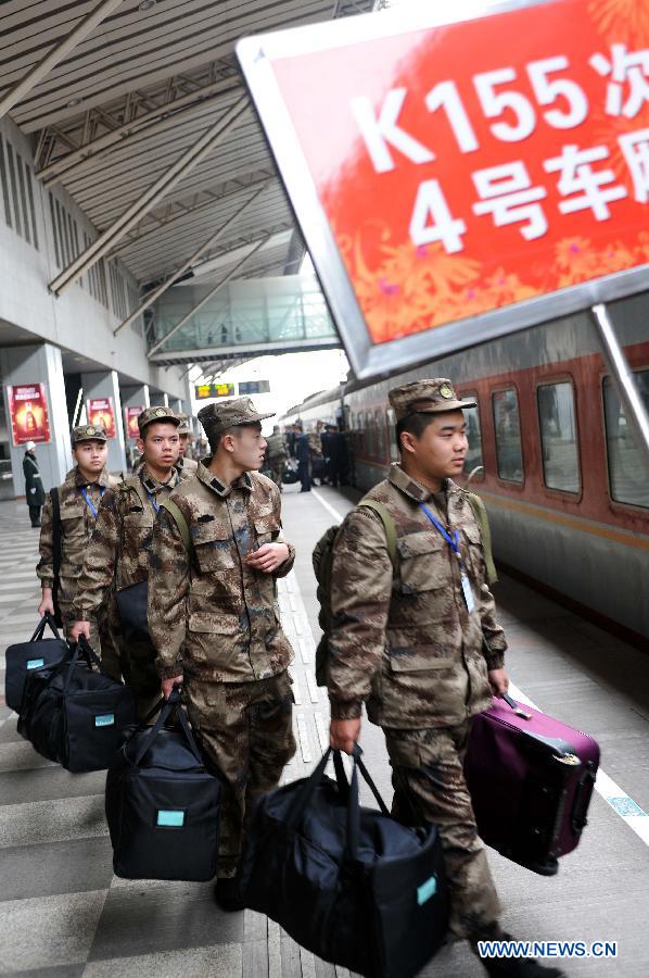 Newly recruited soldiers of People's Liberation Army (PLA) get on a train at Nanjing Railway Station in Nanjing, capital of east China's Jiangsu Province, Dec. 10, 2012. A total of 545 new recruits from Nanjing, Nantong, Taizhou and Yancheng, four cities in Jiangsu, set off on Monday to join their army units. (Xinhua/Sun Can)