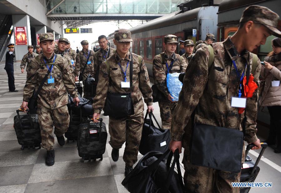 Newly recruited soldiers of People's Liberation Army (PLA) get on a train at Nanjing Railway Station in Nanjing, capital of east China's Jiangsu Province, Dec. 10, 2012. A total of 545 new recruits from Nanjing, Nantong, Taizhou and Yancheng, four cities in Jiangsu, set off on Monday to join their army units. (Xinhua/Sun Can) 