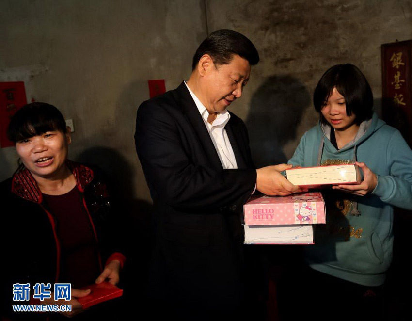 Photo released on Dec. 11, 2012 shows Xi Jinping (C), general secretary of the Communist Party of China (CPC) Central Committee and chairman of the CPC Central Military Commission (CMC), presents books and stationery to a girl in Huanglong Village in Shunde, south China's Guangdong Province. Xi made an inspection tour in Guangdong from Dec. 7 to Dec. 11. (Xinhua/Lan Hongguang)