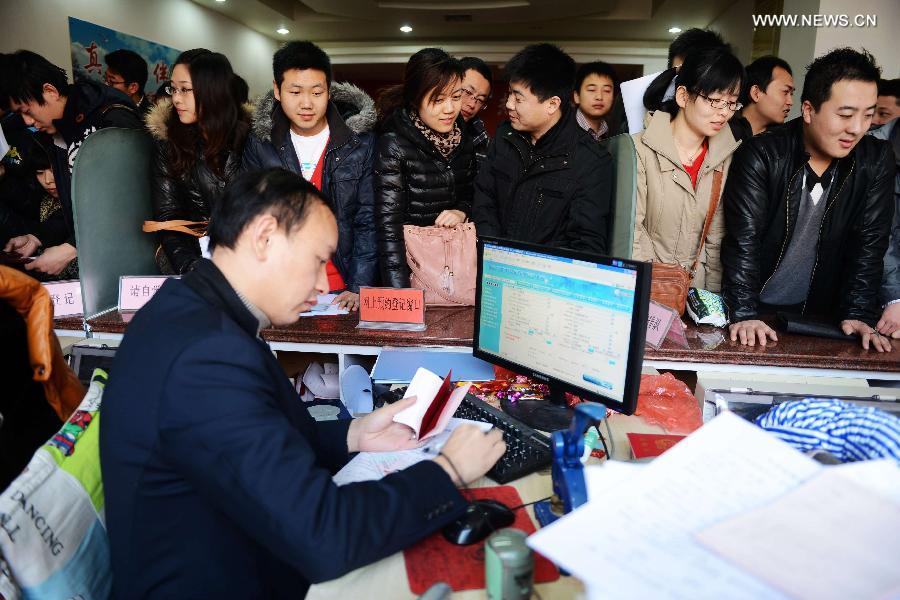 Couples wait to register for marriage at a registration office in Huangdao District of Qingdao City, east China's Shandong Province, Dec. 12, 2012. Young couples across the country rushed to get married on Dec, 12, 2012, or 12/12/12, hoping that the "triple 12 day" will bring them good luck. In Chinese, the number 12 is pronounced like "Yao Ai", meaning "To Love" in English. (Xinhua/Yu Fangping)