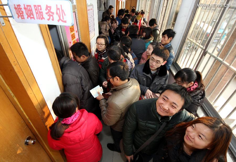 Young couples wait to register for marriage at a civil affairs bureau in Zaozhuang City, east China's Shandong Province, Dec. 12, 2012. Young couples across the country rushed to get married on Dec, 12, 2012, or 12/12/12, hoping that the "triple 12 day" will bring them good luck. In Chinese, the number 12 is pronounced like "Yao Ai", meaning "To Love" in English. (Xinhua/Sun Zhongzhe)