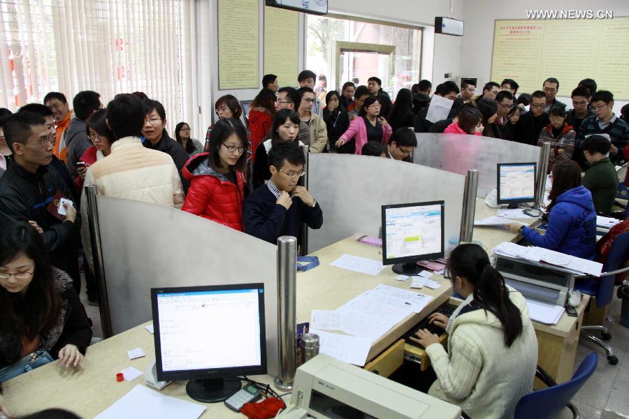 Couples wait to register for marriage at a civil affairs bureau in Shantou City, south China's Guangdong Province, Dec. 12, 2012. Young couples across the country rushed to get married on Dec, 12, 2012, or 12/12/12, hoping that the "triple 12 day" will bring them good luck. In Chinese, the number 12 is pronounced like "Yao Ai", meaning "To Love" in English. (Xinhua/Yao Jun)