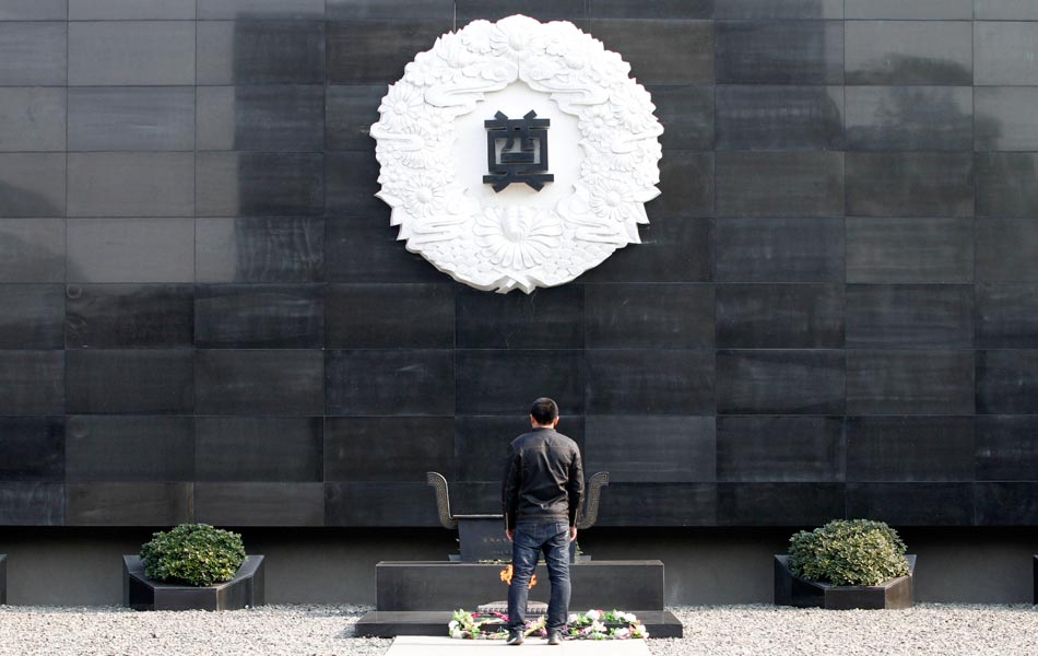 A man prays in front of a memorial wall at the Memorial Hall of the Victims in Nanjing Massacre by Japanese Invaders in Nanjing, capital of east China's Jiangsu Province, on Dec. 13, 2012, to mark the 75th anniversary of the Nanjing Massacre. Nanjing was occupied on Dec. 13, 1937, by Japanese troops who began a six-week massacre. Records show more than 300,000 Chinese unarmed soldiers and civilians were killed. (Xinhua/Dong Jinlin)