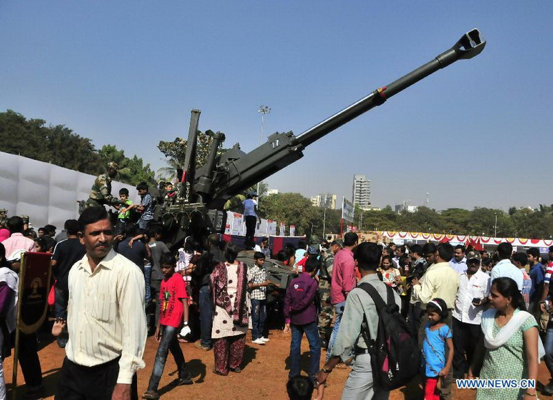 People look at arms exhibition at Shivaji park in Mumbai, India, on Dec. 15, 2012. A troop of Indian Defense Ministry held a military drill and arms exhibition here to raise the public awareness of Indian army and military affairs on Saturday. (Xinhua/Wang Ping) 
