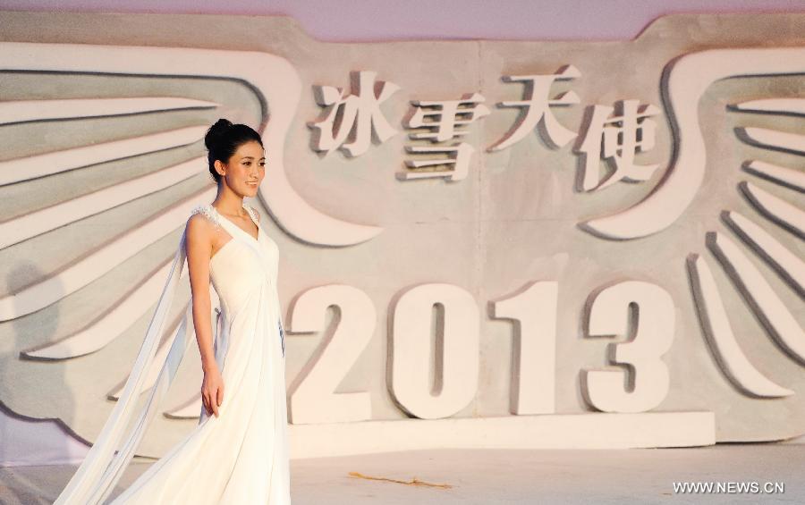 A contestant is pictured on a evening wear show during a beauty contest in Changchun City, capital of northeast China's Jilin Province, Dec. 19, 2012. (Xinhua/Xu Chang) 