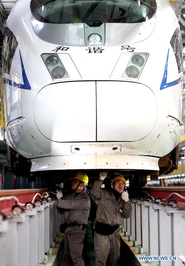 Technicians checks the chassis of a bullet train in Shanghai Municipality, Dec. 19, 2012. Shanghai Railway Bureau conducted a comprehensive overhaul of all the bullet trains to ensure the demand of vehicles during the coming spring rush on Wednesday. (Xinhua/Chen Fei) 
